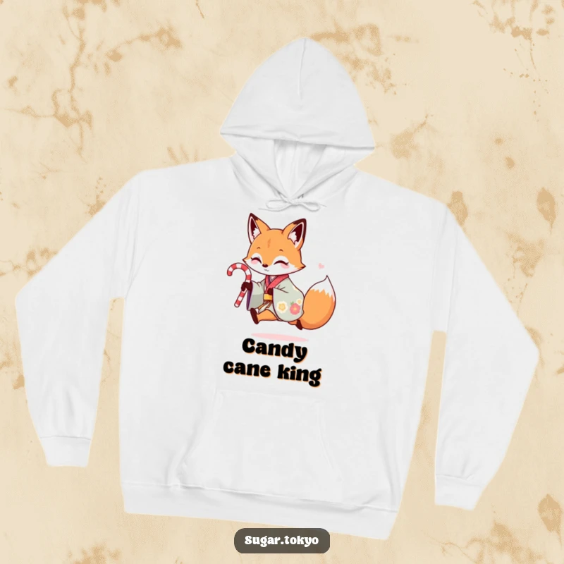 Funny hoodie featuring a playful fox in a colorful kimono skipping with a candy cane, offering cozy comfort and playful, humorous energy.