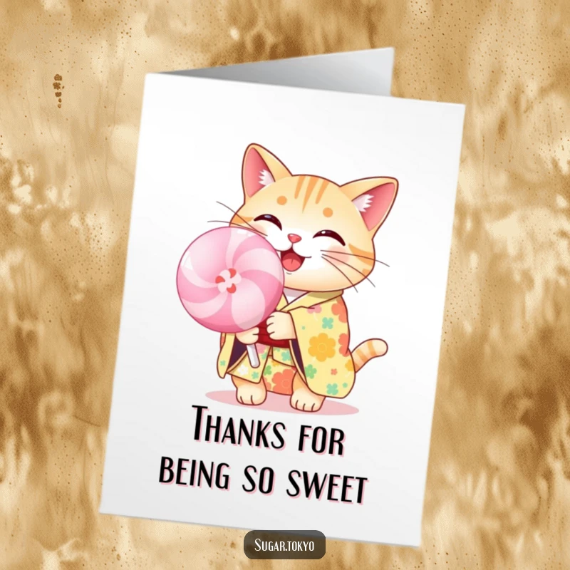 Funny Free Printable Thank You Card: Cheerful cat in a floral kimono holding a big pastel lollipop, saying thank you with sweetness.